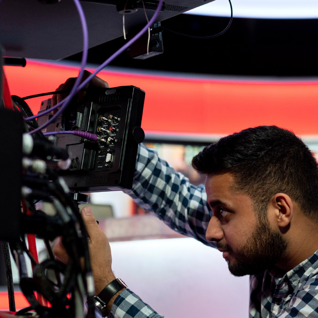 User preparing a camera for live news broadcast